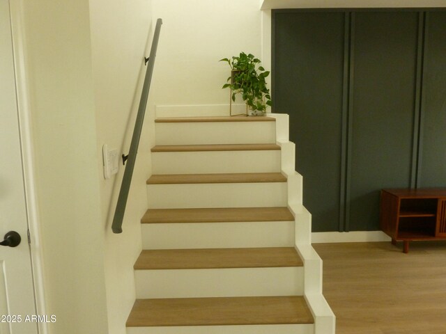 staircase featuring wood finished floors