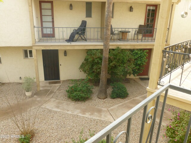 entrance to property featuring stucco siding and a porch