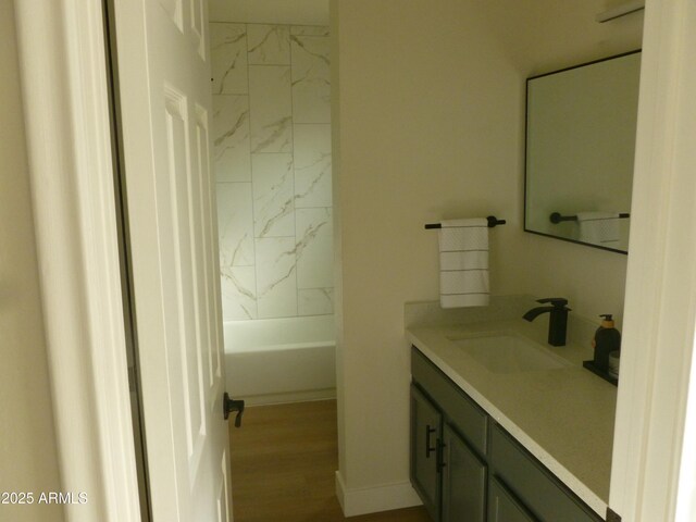 bathroom with shower / washtub combination, vanity, and wood finished floors