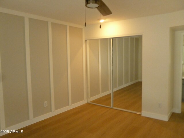 unfurnished bedroom with baseboards and wood finished floors