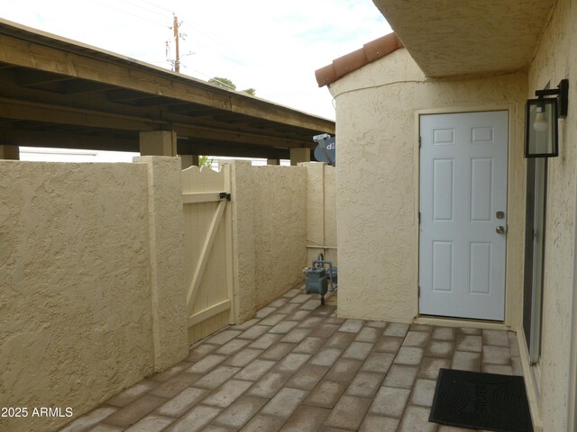 view of patio with fence and a gate