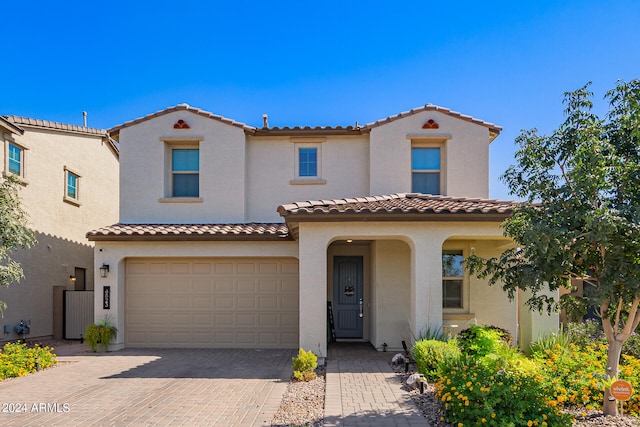 mediterranean / spanish-style house with a garage