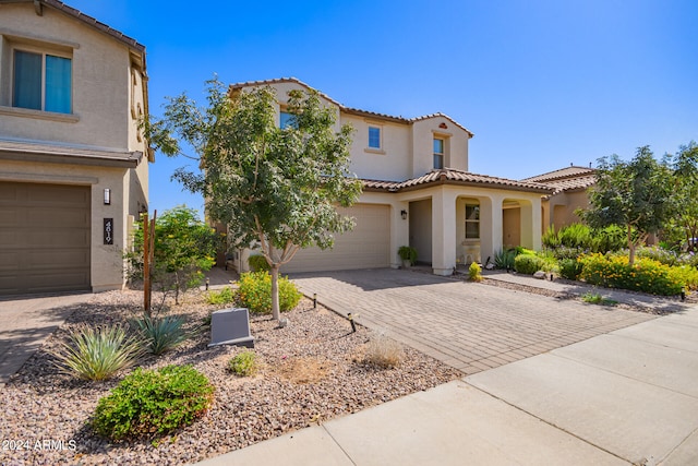 mediterranean / spanish-style home with a garage