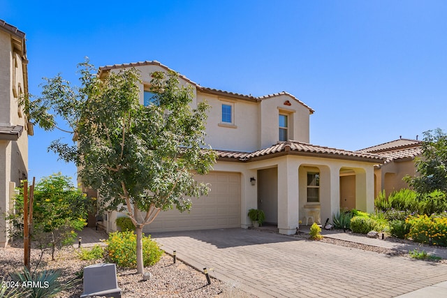 mediterranean / spanish-style home with a garage