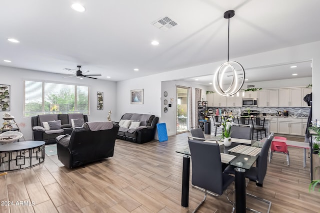 dining area featuring ceiling fan and light hardwood / wood-style floors