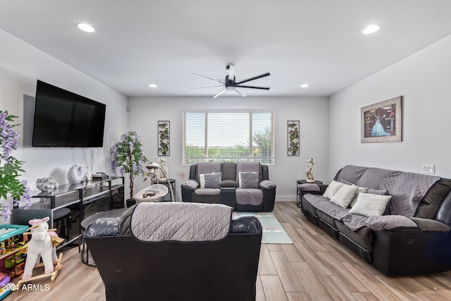 living room with light hardwood / wood-style floors and ceiling fan