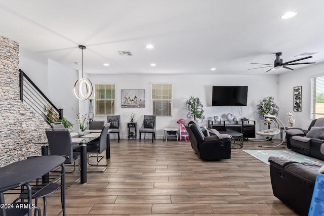 living room featuring hardwood / wood-style flooring and ceiling fan