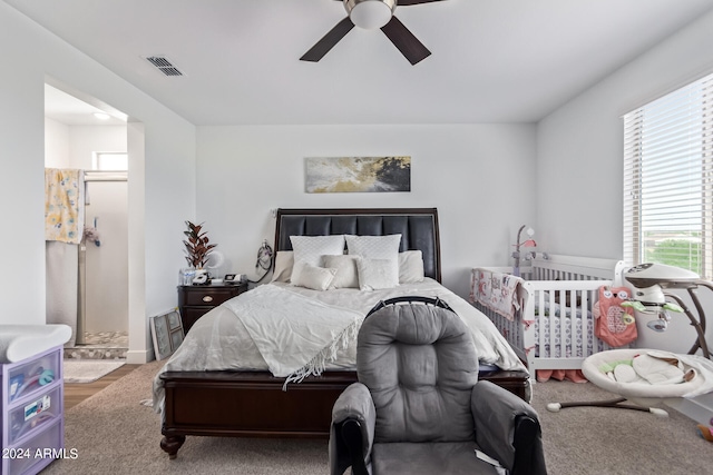 bedroom featuring ensuite bath and ceiling fan