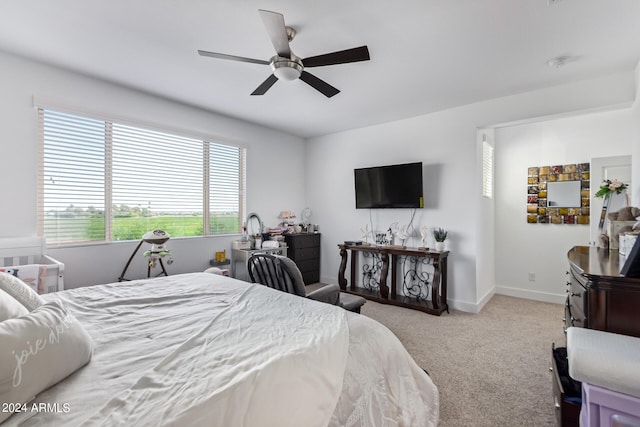 bedroom featuring light colored carpet and ceiling fan