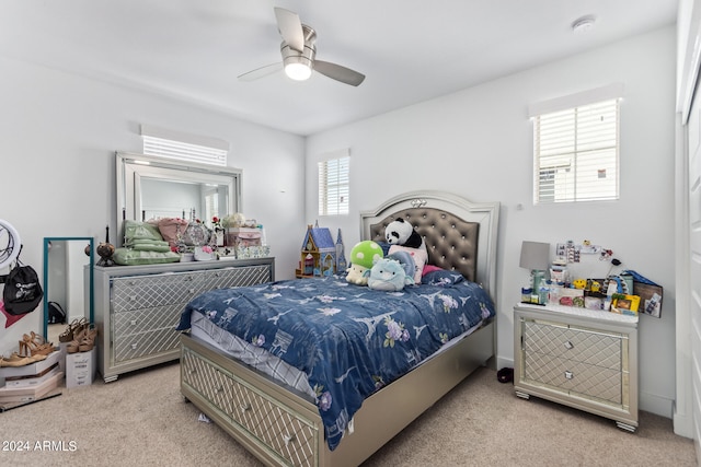 bedroom with ceiling fan and light colored carpet