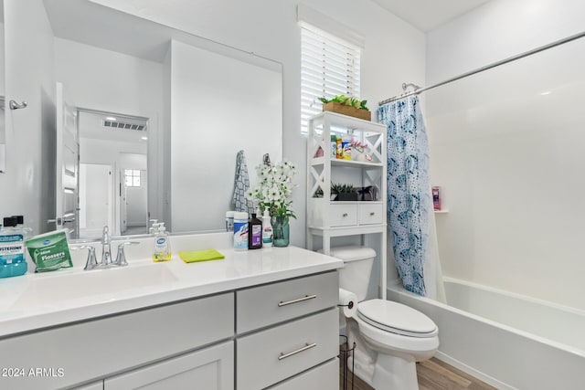 full bathroom with shower / bath combination with curtain, vanity, toilet, and plenty of natural light