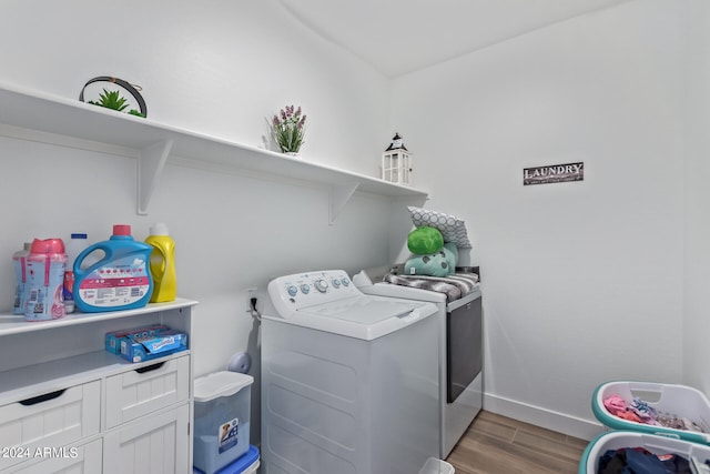 laundry area featuring separate washer and dryer and wood-type flooring