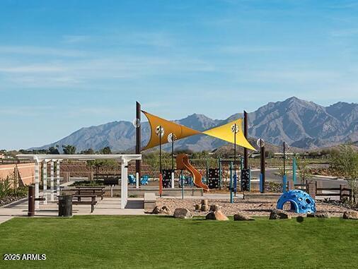 view of play area featuring a mountain view and a lawn