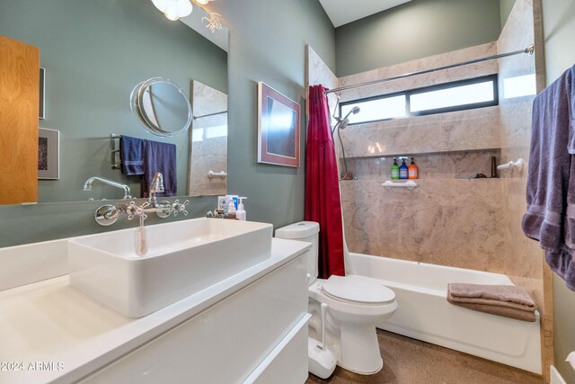 full bathroom with vanity, shower / tub combo, and toilet