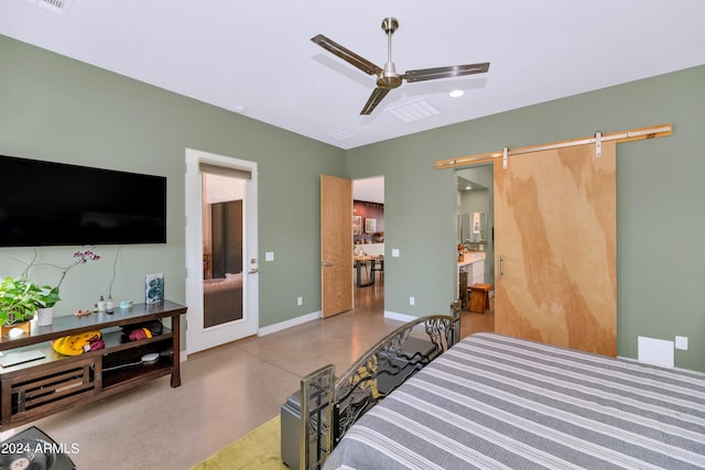 bedroom with concrete flooring, ceiling fan, and a barn door