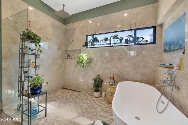 bathroom featuring tile walls and plus walk in shower