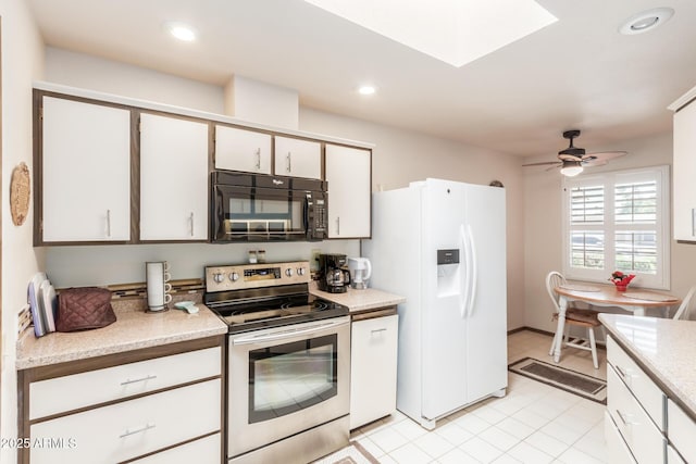 kitchen featuring black microwave, white refrigerator with ice dispenser, stainless steel electric range, and recessed lighting