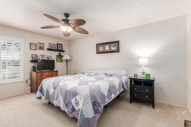 carpeted bedroom with a ceiling fan, visible vents, and baseboards