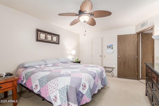 bedroom featuring a ceiling fan, light colored carpet, and visible vents