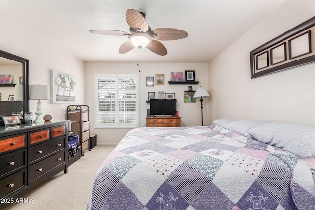 bedroom with light carpet and a ceiling fan