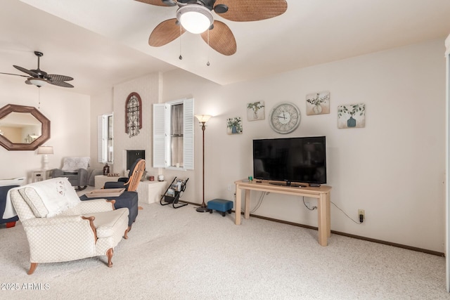 carpeted living area featuring a ceiling fan and baseboards