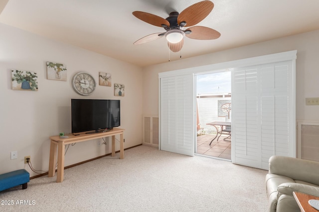 living area with ceiling fan and carpet