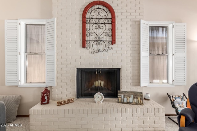 living room featuring a brick fireplace and baseboards