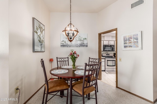 dining room with an inviting chandelier, carpet, visible vents, and baseboards