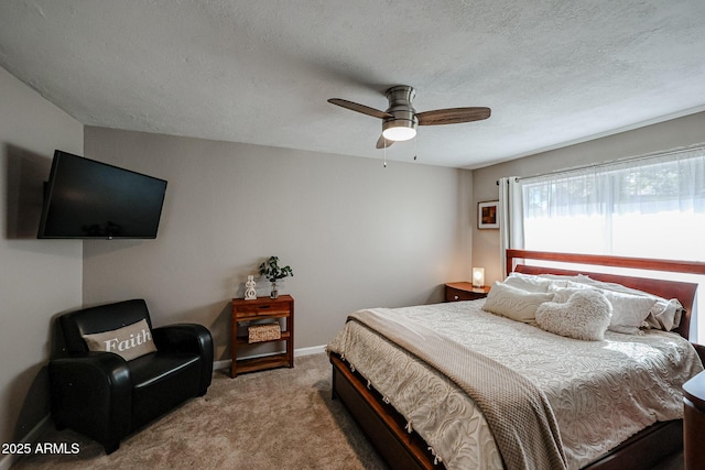 bedroom featuring ceiling fan, a textured ceiling, and carpet