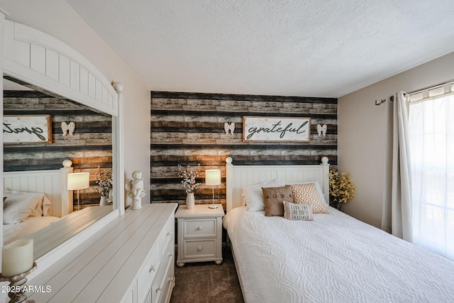 carpeted bedroom with wooden walls and a textured ceiling