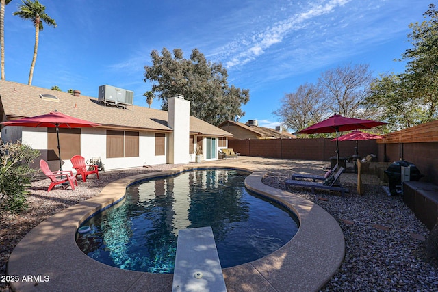 view of swimming pool with central AC, area for grilling, a diving board, and a patio