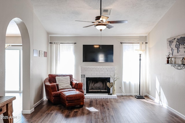 sitting room featuring hardwood / wood-style flooring, a fireplace, and a textured ceiling