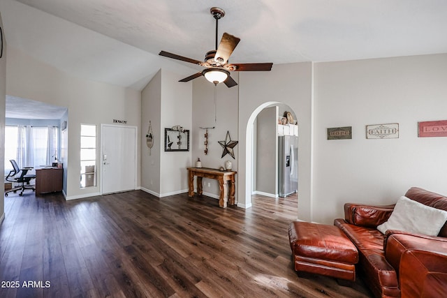 living room featuring dark wood-type flooring, ceiling fan, and high vaulted ceiling