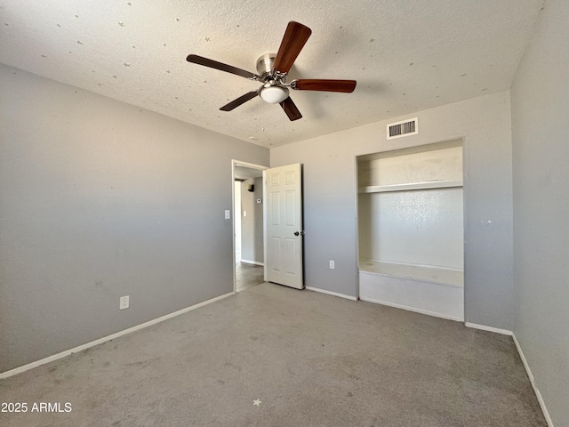 unfurnished bedroom featuring light colored carpet, a closet, and ceiling fan