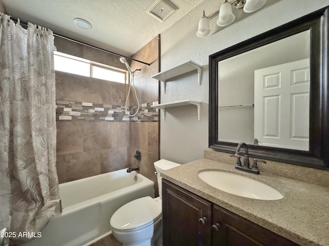 full bathroom with vanity, toilet, shower / bath combination with curtain, and a textured ceiling