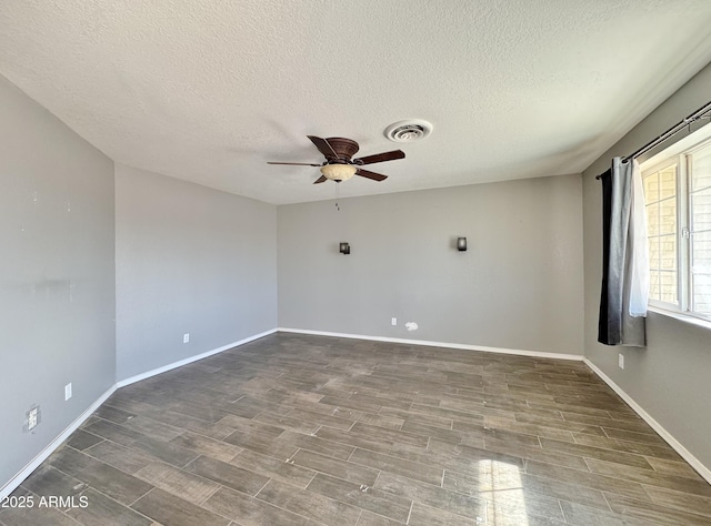 empty room featuring a textured ceiling and ceiling fan