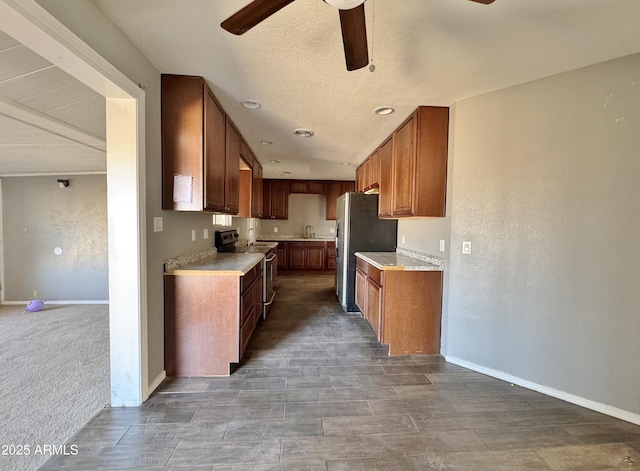 kitchen with ceiling fan, stainless steel appliances, and sink