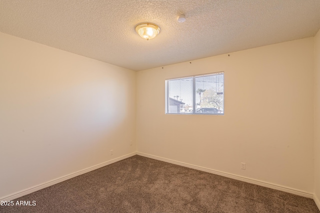 carpeted empty room with a textured ceiling