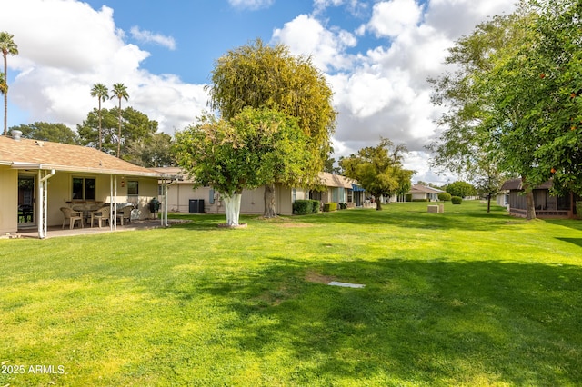 view of yard featuring central AC unit and a patio area