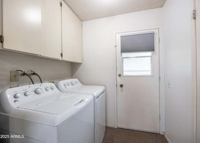 laundry area with baseboards, cabinet space, separate washer and dryer, and a textured ceiling