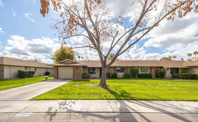 ranch-style home featuring a garage, brick siding, concrete driveway, and a front yard