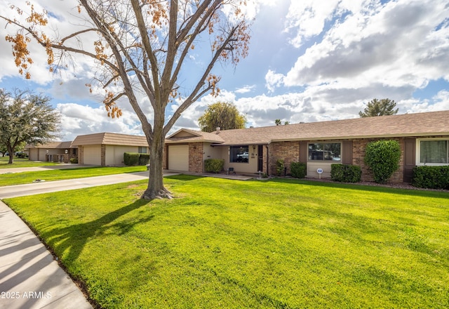 single story home with a garage, brick siding, concrete driveway, and a front lawn