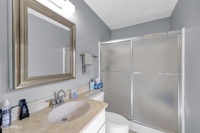 bathroom with vanity, toilet, and a stall shower