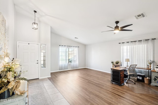 foyer entrance featuring ceiling fan, lofted ceiling, and tile patterned flooring