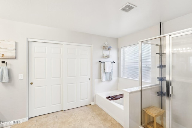 bathroom featuring tile patterned floors and separate shower and tub