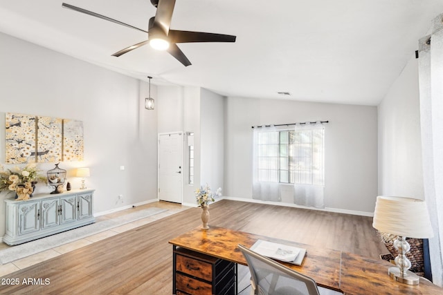 living room with light hardwood / wood-style floors, lofted ceiling, and ceiling fan