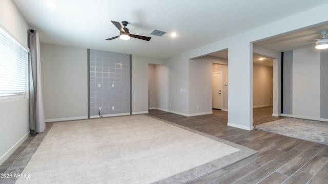 spare room with visible vents, wood finished floors, baseboards, ceiling fan, and recessed lighting