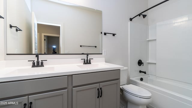 full bath featuring a sink, toilet, double vanity, and  shower combination
