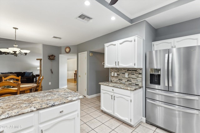 kitchen with white cabinetry, backsplash, light tile patterned flooring, and stainless steel refrigerator with ice dispenser