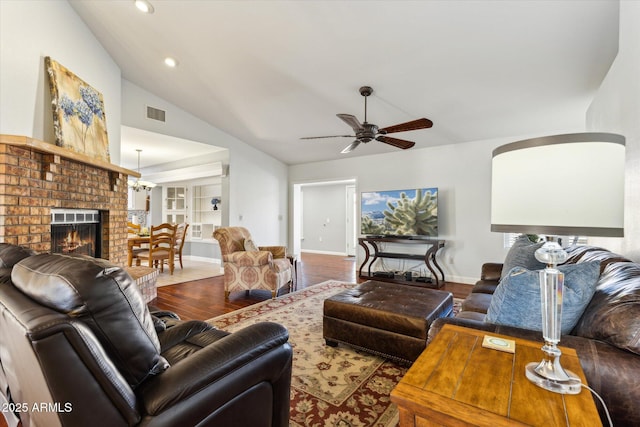 living room featuring hardwood / wood-style flooring, ceiling fan, lofted ceiling, and a fireplace